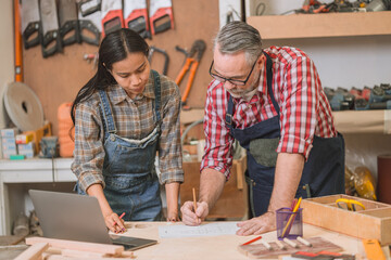 Professional carpenter man working with wood piece design furniture in workshop in wood factory