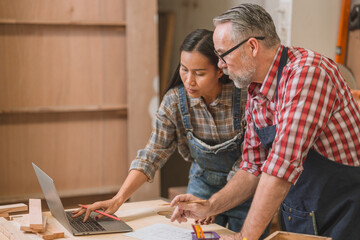Professional carpenter man working with wood piece design furniture in workshop in wood factory
