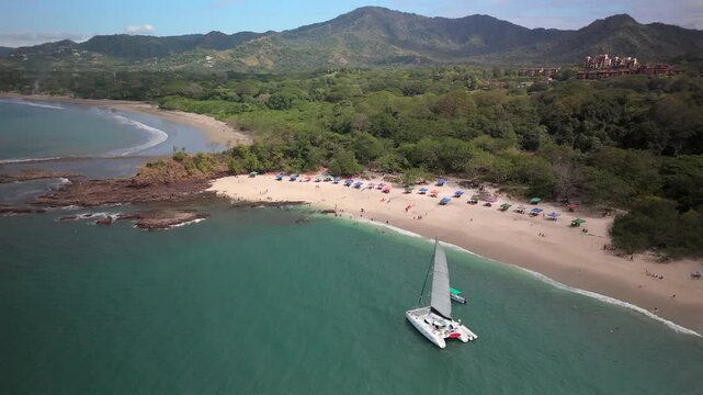Aerial approach of a sailboat off of Conchal Beach in Costa Rica