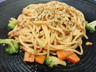 vegetarian pasta dish served in a black plate