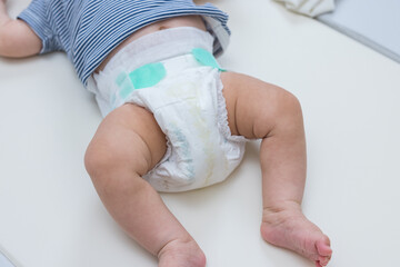 Little baby lying in clean white diaper