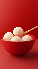 An image of a bowl of tangyuan on a solid color background