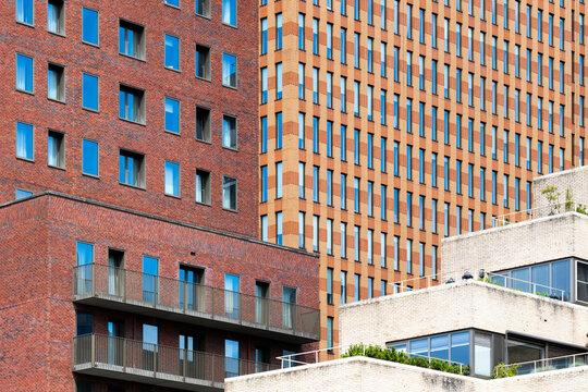 A striking blend of contemporary architecture featuring colorful facades showcasing unique designs, textures, and reflections in modern urban settings in Amsterdam