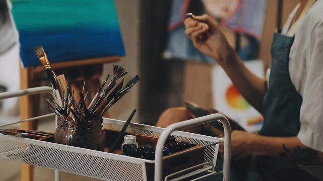 Brush on artist's canvas with mixed paints, closeup