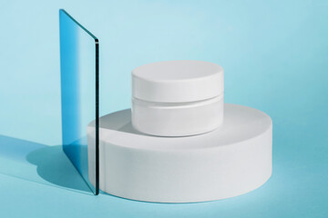 Jar of firming cream placed on round white display with blue glass panel, clean and modern aesthetic. Creme mock up, brand packaging on podium, skincare product, sunscreen cosmetic branding mockup