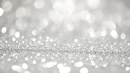 An abstract glittering background sparkles in silver and white.