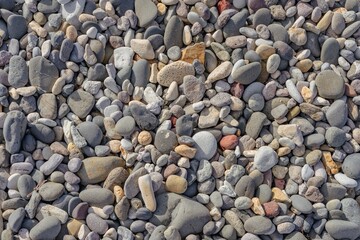 Close-up of colorful pebbles on a beach, with various shapes and textures in Iceland