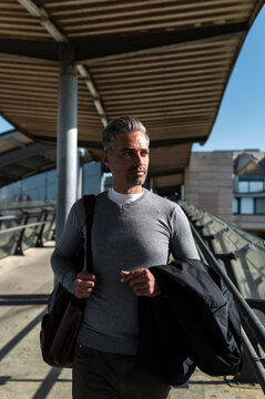 Commuter with gray hair at airport terminal