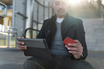 Businessman online banking outdoors