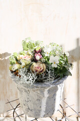 floral bricolage in soft pastel colors, wither pot gardening