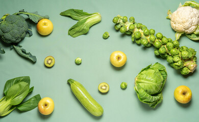 Set of green vegetables and fruits top view on green background