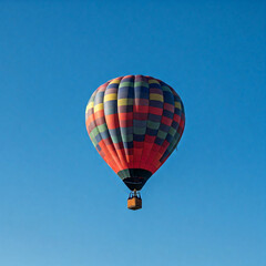 Naklejka premium colorful hot air balloon in the blue sky. Colorful hot air balloon flying on sky. travel and air transportation concept - balloon carnival.