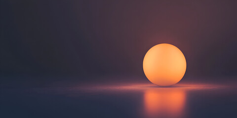 Glowing Orb: A softly glowing orange sphere rests on a dark surface, its light gently reflecting, creating a minimalist and serene atmosphere.  The image evokes feelings of warmth, calm and mystery.