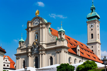 GeneHeilig-Geist-Kirche in Munich, Germany. Holy Ghost Church, facade and clock-tower of the Gothic Hall church close to Munich city centre. 