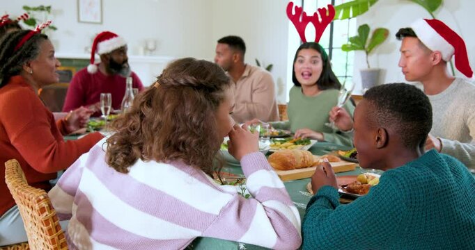At Christmas, Diverse family enjoying festive holiday meal together, sharing laughter and delicious