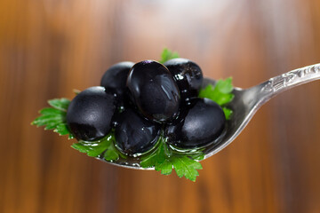 black olives in a spoon