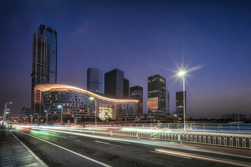 Starry Night Sky over Urban Waterfront and City Lights