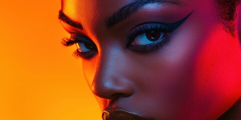 Striking close-up of a model with bold makeup and vibrant lighting