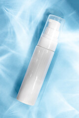 A white cosmetic tube on a pastel blue background. Ideal for mockups, branding presentations, and product marketing