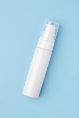 A white cosmetic tube on a pastel blue background. Ideal for mockups, branding presentations, and product marketing