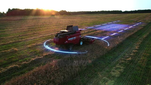 Aerial view of an autonomous self-driving harvester with autopilot, harvesting grain from an agricultural field using GPS navigation system for positioning. Futuristic agriculture, HUD-animation, 4k.