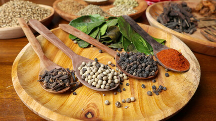 spices and herbs on wooden spoons
