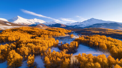 Golden fields under snowy mountains in autumn