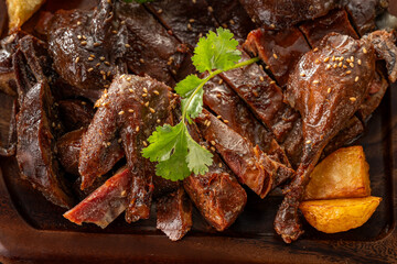 Roast duck is placed on a wooden board