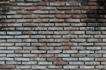 Vintage brown bricks block wall with soft lighting background. Grunge wallpaper for decorative or design. Restricted area or obstruction concept.