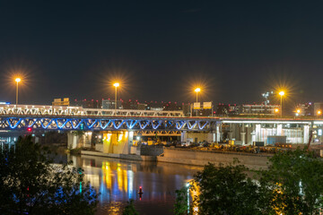 The scyscrapers of the Moscow City at night and the Dorogomilovsky bridge with illumination. Translation of text - street names: Krasnopresnenskaya, center, etc.