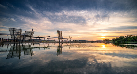 Fototapeta premium Serene Sunset Over Reflective Waterscape