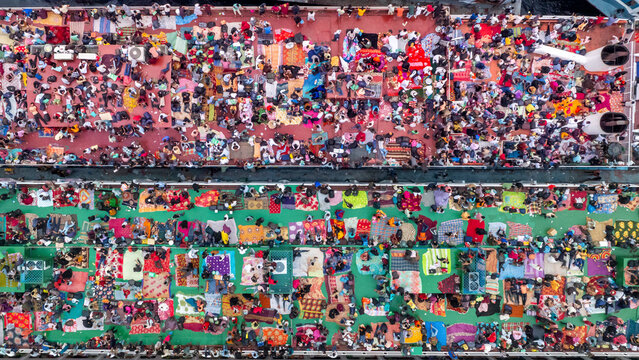 Aerial view of colourful ferry rooftops with muslims returning home for eid and holiday masses of travellers on the buriganga river, Subhadya, Dhaka, Bangladesh.