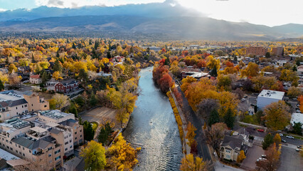 Aerial view of vibrant autumn foliage in downtown Reno with a scenic river and cityscape, Reno, United States.