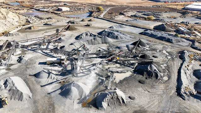 Aerial view of mining operations at an industrial quarry with heavy machinery and uncompleted structures, Spanish Springs, United States.