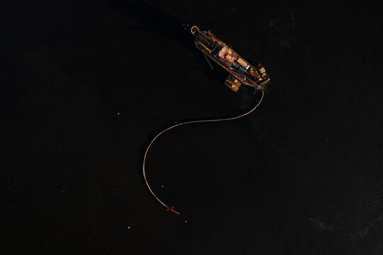 Aerial view of serene Oglethorpe Bay with moored fishing boats and dark calm water, Brunswick, USA.