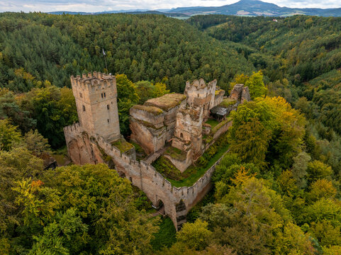 Aerial view of the abandoned medieval Burg Helfenburk castle surrounded by autumn forest and trees, Ustek, Czech Republic.