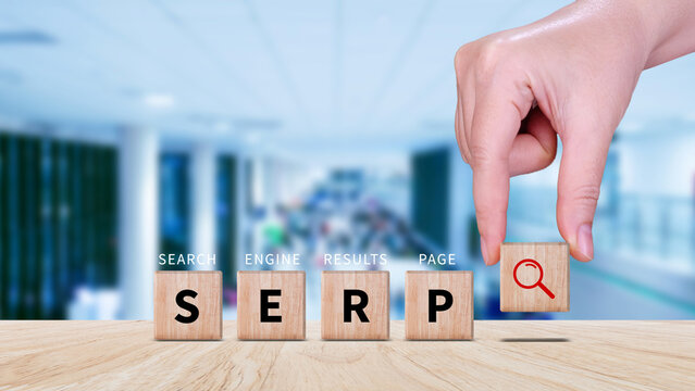 SERP, Search Engine Result Pages concept, magnifying glass and wooden cube with text SERP, can be used for business, marketing and education concept