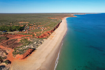 Aerial view of barn hill beachside station stay with ochre cliffs and sandy beach, Broome, Australia.