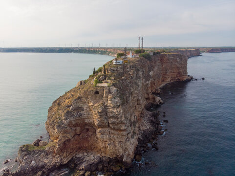 Aerial view of the majestic Cape Kaliakra with rugged cliffs and serene ocean at sunset, Kavarna, Bulgaria.