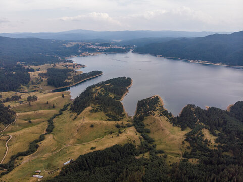 Aerial view of tranquil Dospat reservoir surrounded by picturesque mountains and lush greenery, Dospat, Bulgaria.