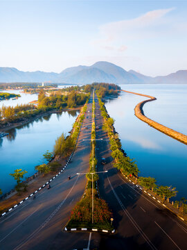 Aerial view of serene Ulee Lheu Bay with calm ocean and scenic mountains, Aceh, Indonesia.