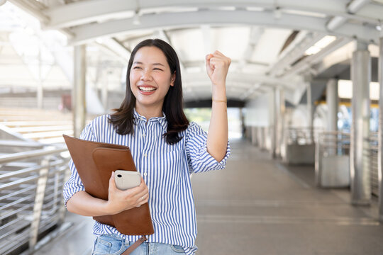 close up young beautiful asian businesswoman raised hand with happiness feeling after complete and get a new job position in city for new career path concept