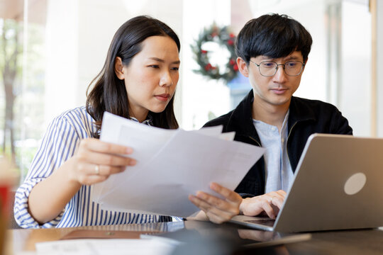 close up group of young businesswoman and businessman check task or prove about statement or report annual with stress feeling at office for business lifestyle and data analytics concept - Powered by Adobe