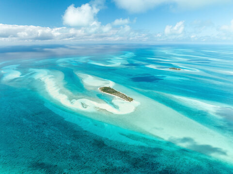 Aerial view of a beautiful tropical island with turquoise waters and sandy beaches, South Eleuthera, The Bahamas. - Powered by Adobe