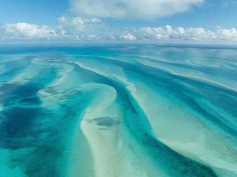Aerial view of beautiful turquoise ocean and sandy beach with tropical coast, South Eleuthera, The Bahamas. - Powered by Adobe