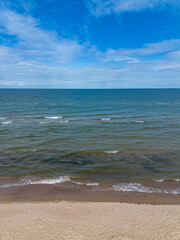 Baltic sea waves rolling on sandy shore, top view. Sea background