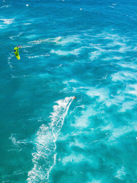 Aerial view of kite surfers riding vibrant waves in the turquoise ocean, Sosua, Dominican Republic.