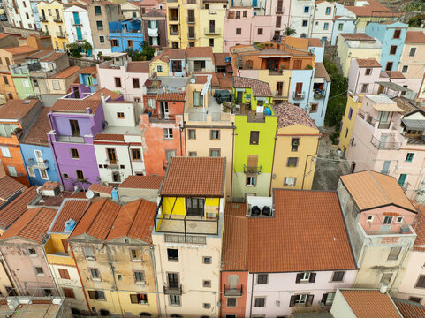 Aerial view of colorful medieval buildings and rooftops in the old town, Bosa, Italy.