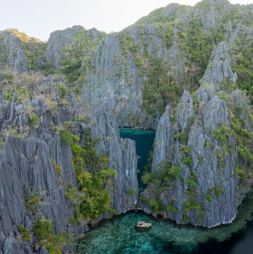Aerial view of twin lagoon surrounded by limestone cliffs and turquoise water, Banuang Daan, Coron, Palawan, Philippines.