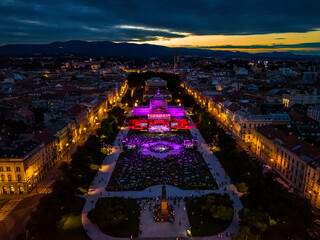 Aerial view of vibrant concert in old town with illuminated buildings and a lively crowd, Zagreb, Croatia.